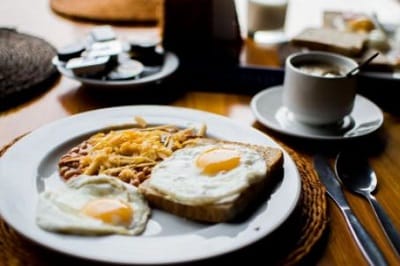 breakfast meal with sunny side up eggs and beans and coffee to show a balanced meal