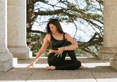 woman doing a seated yoga pose to symbolize the introspective journey of releasing trapped emotions
