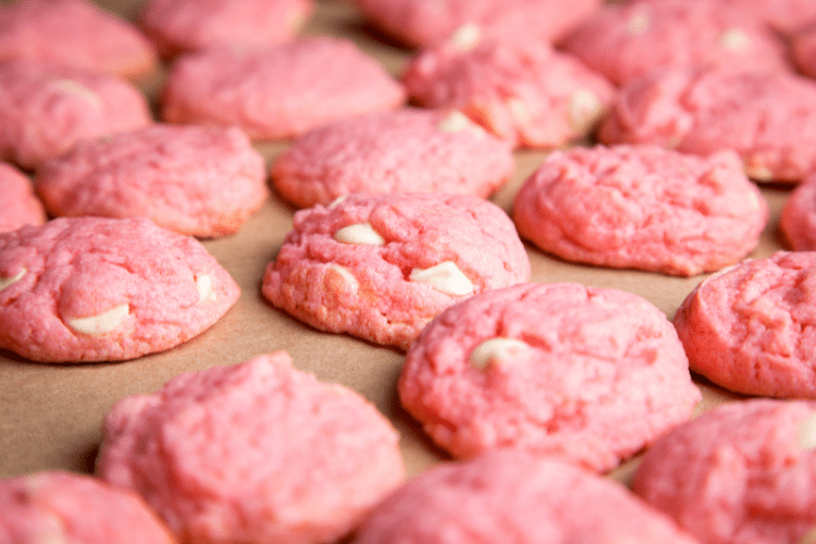 beautiful pink cookies sitting on a baking sheet to symbolize a food commonly used as a reward